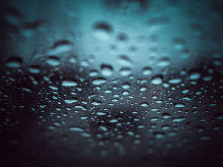 Rain drops on the glass during the heavy rains in the rainy season.の写真素材