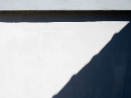 White cement wall fence empty There are light and shadow contrasting on the wall.の写真素材