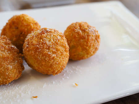 The cheese ball is on a white plate. with copy space.の写真素材