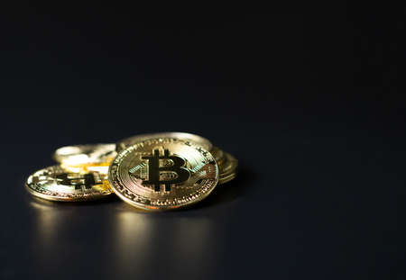 Bitcoin Coins as Cryptocurrency placed on a black backgroundの写真素材