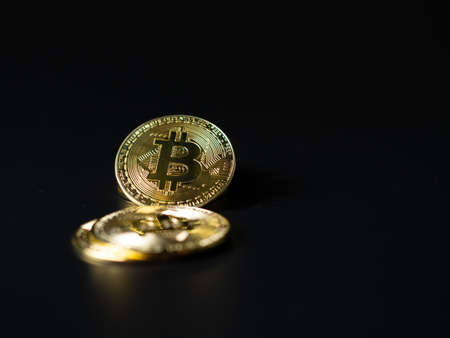 Bitcoin Coins as Cryptocurrency placed on a black backgroundの写真素材