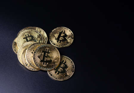 Bitcoin Coins as Cryptocurrency placed on a black backgroundの写真素材