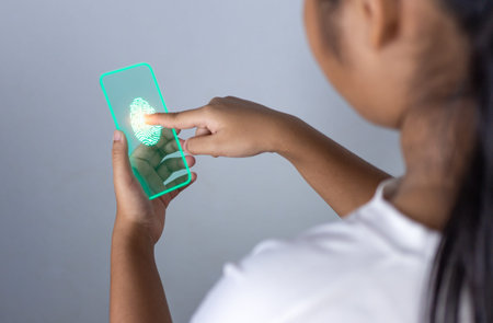 People's fingers are pressing on the phone screen. Represents protection against external hacks, code protection security concepts, viruses, firmware and malware.の写真素材