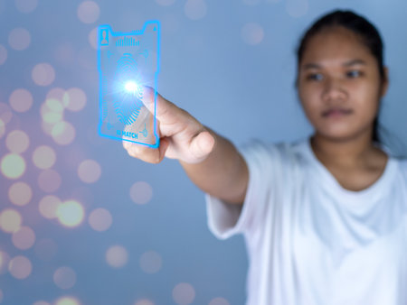 People fingers are pressing on the fingerprint scanner screen. Represents protection against external hacks, code protection security concepts, viruses, firmware and malware.の写真素材