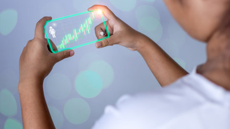 Hologram image of a candlestick chart from a phone on a person's hand. Offer trading concept, investment ideasの写真素材