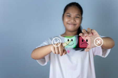 Hand choosing happy smile icon. represents feedback rating and positive customer review, Satisfaction Concept, satisfaction survey ,mental health assessment, world mental health day, think positive conceptの写真素材