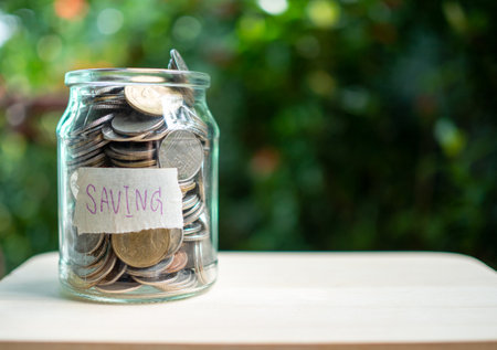 Piggy bank bottle with saving sign on natural bokeh backgroundの写真素材