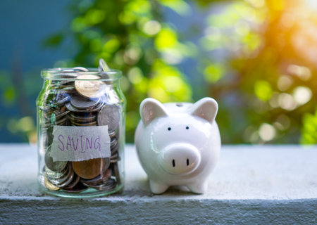 Piggy bank bottle with saving sign on natural bokeh backgroundの写真素材