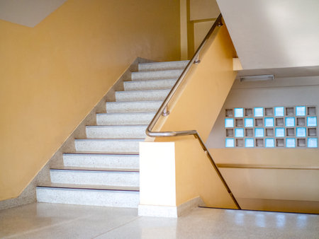 Stairways are concrete in multi-storey buildings and have steel handrails.の写真素材