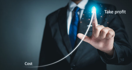 Stock trading. Finance. Investing. Growing business. Businessman in suit showing finger pointing to arrow tip on gray background.の写真素材