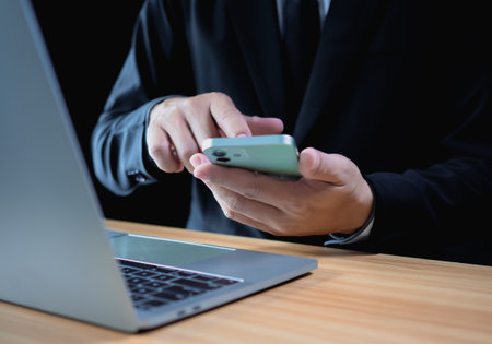Businessman using phone and computer for work. Business concept. communication conceptの写真素材