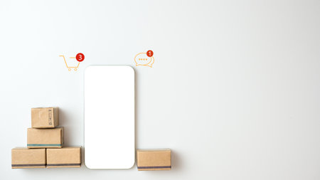 Shopping concept. Cardboard box and phone with blank screen on white background. Online shopping consumers can choose from home shopping and delivery services. with copy space.の写真素材