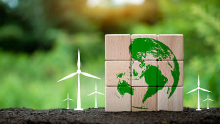 Stacked wooden blocks with globe icon and windmill on nature background. It's a concept to help preserve the environment. Concept of saving the world.の写真素材