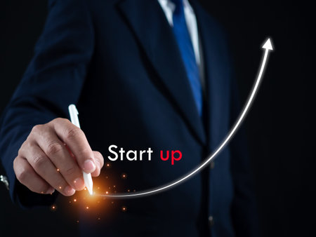 Businessman presses the pen at the starting point to start a business. Startup concept. Business...
