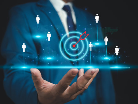 Businessman shows dart board in selecting business target group, target customers, buyers, customer behavior concept, marketing plan and strategy, personal marketing, customer centric strategy.の写真素材