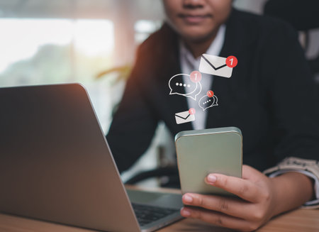 Businesswoman uses smartphone to check new email. New email notification ideas for business email...