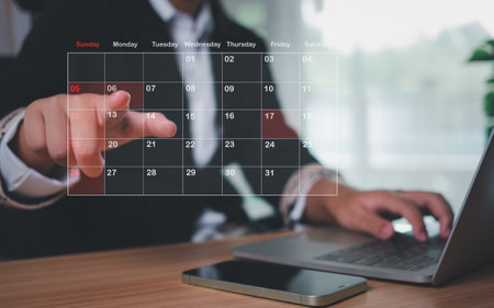 Businesswoman marking dates on virtual calendar, managing his business schedule, setting reminders for important appointments, creative collage for planning ideas, appointment schedulerの写真素材
