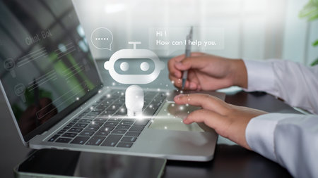 Businessman uses computer to type chat question and answer with artificial intelligence system or chatbot and represents artificial intelligence assistant.の写真素材