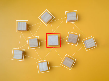 Connected wooden blocks on a yellow background It represents the concept of communication and...