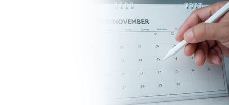 Businessman marking dates on calendar, managing his business schedule, setting reminders for important appointments, creative collage for planning ideas, appointment schedulerの写真素材