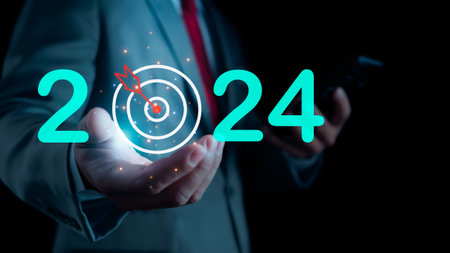 Businessman showing letters 2024 showing setting goals for 2024, startup concept. Financial planning, development, business strategy Setting business goalsの写真素材