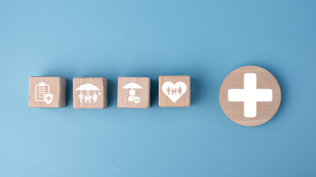 Concept of health insurance and medical. Wooden block with icons about health insurance and access to health care, health care planning on a blue background.の写真素材