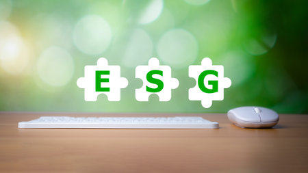 Keyboard and mouse placed on a wooden background with letters printed on a white Jigsaw icon representing ESG concepts for environmental, social and governance, business environmentally responsible.の写真素材
