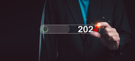 Businessman touch on virtual bar status to change to 2024, countdown of merry Christmas and happy new year by technology concept, start new business and new life. New year's start-up.の写真素材