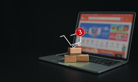 Boxes on a laptop keyboard on dark background. Ideas about online shopping, online shopping is a form of electronic commerce that allows consumers to directly buy goods from seller over the internet.の写真素材