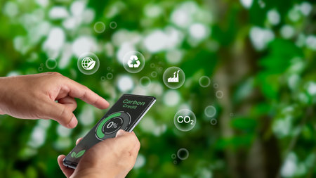 Human using a smartphone to trade carbon credit on application, carbon credit concept, carbon etf to invest in sustainable business, green climate funds investment, Net zero emission, Clean technologyの写真素材