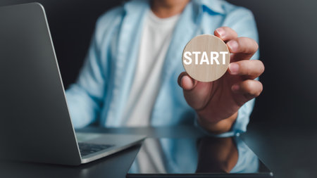 Businessman showing circle wooden and start lettering on desk with computer and tablet, Starting a new business, Planning to start a business, business Goal of future.の写真素材