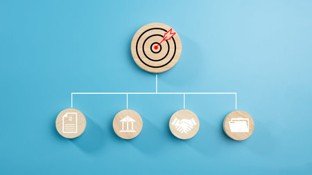 Circular wood with printed target icons and business symbols on light blue background, business...