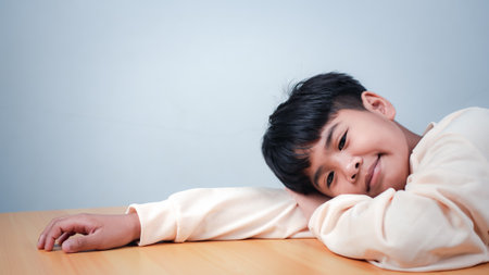 The boy was sitting and thinking about various stories, analyzing and sorting things out.の写真素材