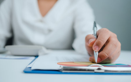 Business woman people use computers and paper documents to analyze business and manage corporate information. Business analysis with charts, indicators, and KPIs to improve organizational performance.の写真素材