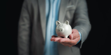 Businessman holding the white piggy bank for saving money concept, Money saving concept, Save for investment, banking, loan, home loan, Financial planning, education and healthy insurance.の写真素材