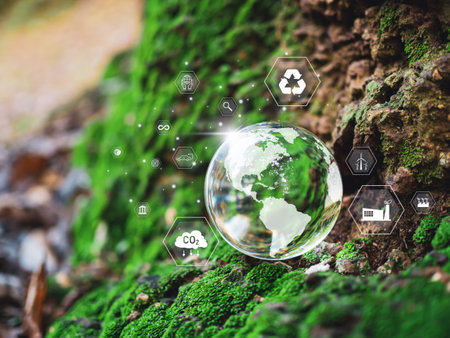 A glass sphere with a world map on it. Spheres set on a wooden floor with various icons and symbols. Scene is one of environmental awareness and sustainable business. Reduce carbon dioxide by 2050.の写真素材