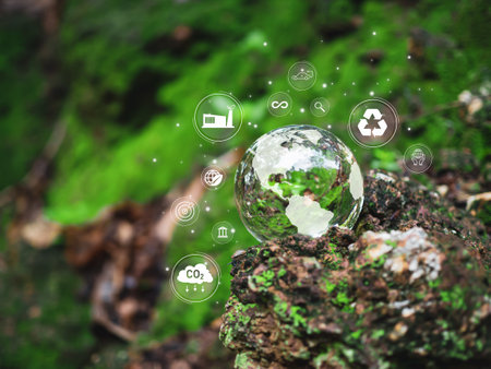 A glass sphere with a world map on it. Spheres set on a wooden floor with various icons and symbols. Scene is one of environmental awareness and sustainable business. Reduce carbon dioxide by 2050.の写真素材