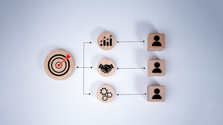 Circular wood with printed target icons and business symbols on white background, Business goals and objectives concept, Business competition, Customer relationship management concept.の写真素材