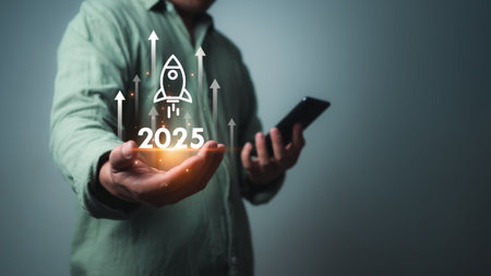 Businessman using smartphone with rocket icon and text 2025 for fast start up business, Startup...
