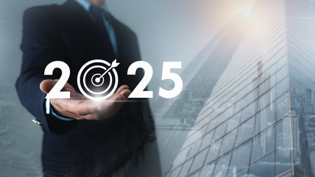 Businessman holds text 2025 with arrow target, Set goals for 2025,  Implementation of business goals...