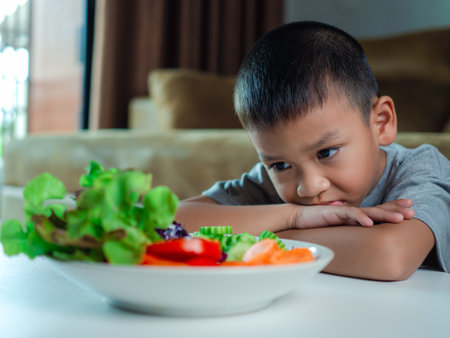 Children do not like to eat vegetables, Little cute boy refuses to eat healthy vegetables, Nutrition healthy eating habits for kids concept, Children do not like to eat vegetables.の写真素材