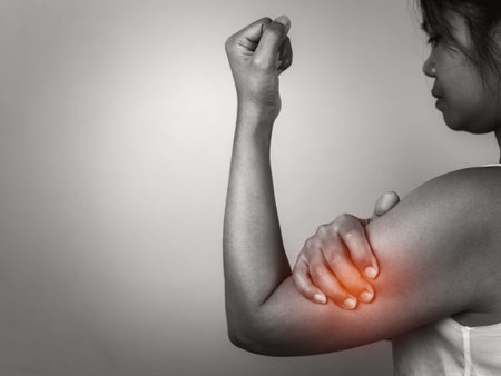 Woman with acute pain elbow with arm pain on gray background, Elbow and arm treatment, Female massaging her elbow muscle spasm, Healthcare and medical concept, Injuries and medical concept.の写真素材