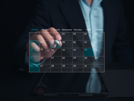Businessman marking dates on virtual calendar with tablet, Managing his business schedule, Setting...