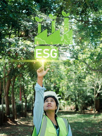 Woman engineer wearing a safety helmet on his head check the weather conditions of nature and...