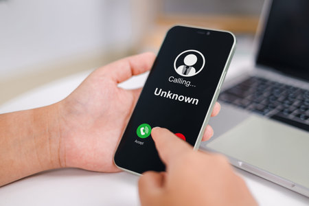 Woman receives a phone call from an unknown number. Concept of scammers or strangers, fraud, and...