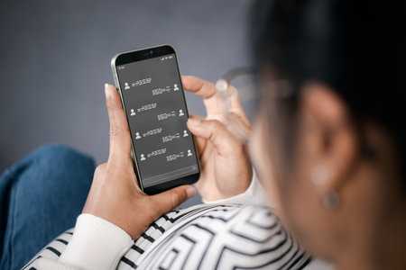 Wireless communications and social concept. Woman with smartphone with instant messaging on the screen. All screen graphics made up. Woman using instant messaging app on mobile phone.の写真素材