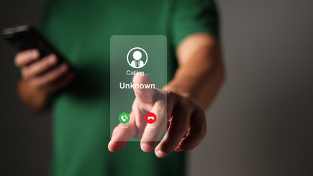 Man answering to incoming call, Phone call from unknown number, Unknown number calling in the middle of the night, Phone call from stranger, Call center gang, scammer or stranger.の写真素材