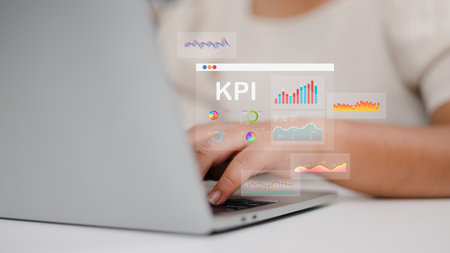 Women use laptops to analyze key performance indicators with various graphs and charts, Showcasing data analysis, and performance tracking. KPI, Key Performance Indicators Analysis.の写真素材