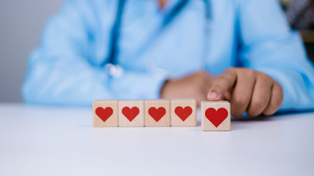 Healthcare worker and doctor service, Doctor showing a red heart on wooden block at hospital office,...
