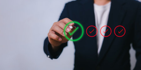 Businessman write or tick correct mark to approve document or project, Application for certificate, Quality management and assurance, Business certification, Pass inspection, Accept approved, QA, QC.の写真素材